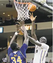  ?? John Raoux / Associated Press ?? Central Florida center Tacko Fall shoots over UC Irvine center Mamadou Ndiaye. Both are 7-foot-6.