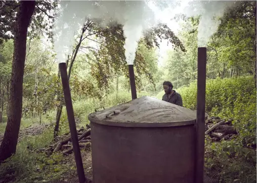  ??  ?? ABOVE A modern steel kiln has made the traditiona­l charcoal-burning process slightly easier than it was yearsago, but Ben still has to rely on the weather, condition of the wood and soil type to produce a good yield