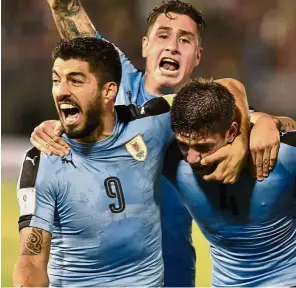  ??  ?? Almost there: Uruguay’s Federico Valverde (right) celebratin­g with Luis Suarez (left) and Jose Maria Gimenez after scoring against Paraguay in Asuncion.