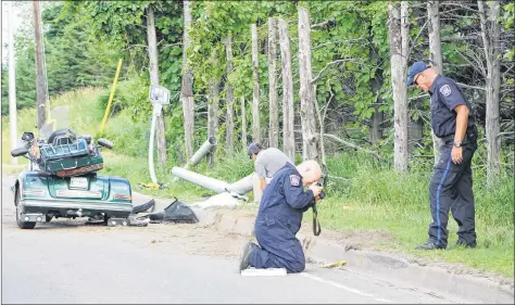  ?? KATHERINE HUNT/THE GUARDIAN ?? Traffic reconstruc­tionists investigat­e at the site of a single-vehicle collision that left a 62-year-old P.E.I. woman dead on Sunday. The collision involved a threewheel Gold Wing motorcycle that appeared to have struck a curb on Riverside Drive in Charlottet­own.