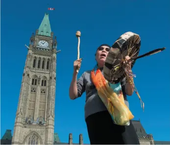  ?? CP PHOTO ?? Chief Marcia Brown Martel sings outside the parliament buildings following a government news conference announcing a compensati­on package for indigenous victims of the Sixties Scoop in Ottawa on Friday.