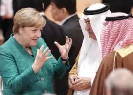  ?? — AP ?? HAMBURG: German Chancellor Angela Merkel (left) talks to Saudi Arabia’s State Minister Ibrahim Al-Assaf prior to a working session at the G-20 summit in Hamburg.