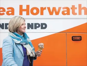  ?? NATHAN DENETTE
THE CANADIAN PRESS ?? Andrea Horwath holds her ice cream cone as she gets on her campaign bus in Guelph on Tuesday.