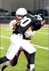  ??  ?? Blackhawk freshman Tristan Hall was tackled on his way to the goal Thursday night in the contest against Huntsville.