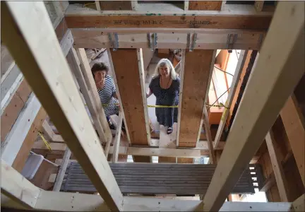  ?? TANIA BARRICKO/DAILY FREEMAN ?? Laurie Schwartz, left, cofounder and board Chair of Circle of Friends for the Dying, and Board of Directors and Communicat­ions/Editor Ann Hutton, look up through what will be an elevator shaft for the Jim and Lisa’s Circle Home in Kingston, N.Y.