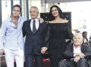  ?? CHRIS PIZZELLO/THE ASSOCIATED PRESS ?? Kirk Douglas, right, seen with grandson Cameron, left, son Michael and Michael’s wife Catherine Zeta-Jones, celebrated his 102nd birthday over the weekend.