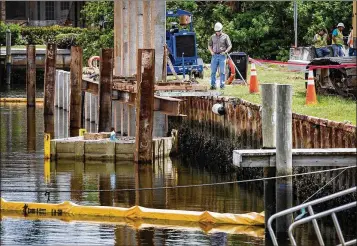  ?? ALLEN EYESTONE / THE PALM BEACH POST ?? Alan Gerwig, design engineer at Alan Gerwig &amp; Associates, looks over the progress at the Anchorage Park marina in North Palm Beach last week. New pilings are being hammered into the canal bed to hold cantilever cement panels to replace the decaying steel panels.