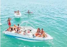  ?? | Unsplash ?? A GROUP of friends on a yacht enjoying the sun and water.