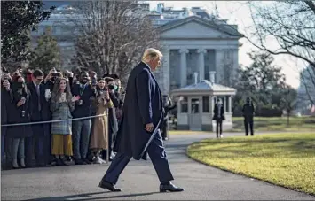  ?? Jabin Botsford / Washington Post News Service ?? President Donald Trump greets visitors and staff as he walks to board Marine One and depart from the South Lawn at the White House on Tuesday. His term ends on Wednesday.