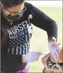  ??  ?? Jennifer Klepps, LPN, vaccinates a patient at the Community Health Center’s walk-in COVID-19 vaccinatio­n clinic at Cove Island Park in Stamford on Sunday.