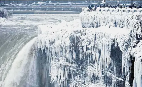  ?? — AP ?? Chillingly beautiful: Visitors taking photograph­s at the brink of the Horseshoe Falls at the Niagara Falls. Almost every year, frigid temperatur­es transform the falls into an icy winter wonderland.