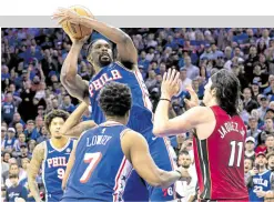  ?? —USA TODAY SPORTS ?? 76ers center Joel Embiid (with ball) was a towering presence in the showdown against the Heat.