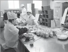  ?? PROVIDED TO CHINA DAILY ?? Employees pack epidemic prevention and control remedies at Jiuxin TCM’s factory in Wuhan, capital of Hubei province, in mid-April.