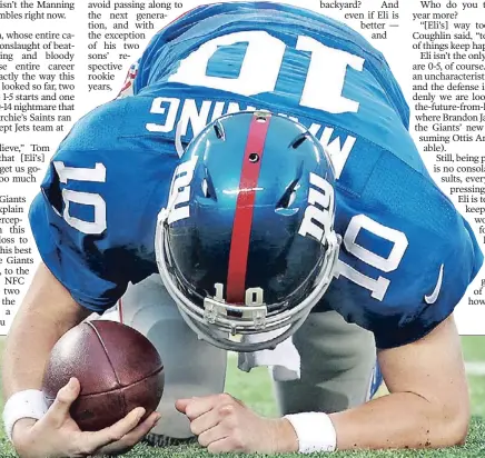  ?? N.Y. Post: Charles Wenzelberg ?? DOWN & OUT: Eli Manning, who threw three more intercepti­ons to bring his season total to 12, kneels on the ground after being sacked during the Giants’ 36-21 loss to the Eagles Sunday at MetLife Stadium.