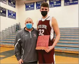  ?? Contribute­d photo ?? Bristol Central senior center Donovan Clingan, right, stands with head coach Tim Barrette after surpassing 2,000 career points in a victory over Bristol Eastern.