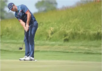  ?? MICHAEL MADRID, USA TODAY SPORTS ?? Defending champion Dustin Johnson putts Thursday on the 17th green, where he shot a bogey.