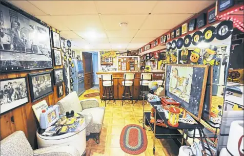  ?? Nate Guidry/Post-Gazette photos ?? Old records, photos and sports memorabili­a fill the basement rec room.