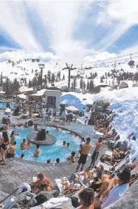  ?? Squaw Valley Alpine Meadows ?? Left: The 50-person hot tub at Squaw Valley’s High Camp has opened for the spring season. Far left: A Tahoe enthusiast combines the best of summer and winter as he paddles Donner Lake.