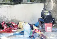  ??  ?? Groom Mario Skeen working in the stables area at Caymanas Park last week.