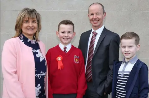  ??  ?? Gaelscoil Inis Córthaidh pupil Dara Cahill at his Confirmati­on, with his parents Edel and Ed and brother Jamie.