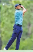  ?? ?? Tiger Woods plays his shot from the 14th tee during the second round of The Masters on Friday