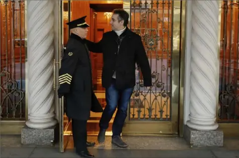  ?? Richard Drew/Associated Press ?? Michael Cohen leaves Friday from his apartment building on New York’s Park Avenue.