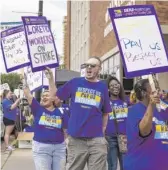  ?? ASHLEE REZIN/SUN-TIMES ?? Striking workers represente­d by SEIU Healthcare Illinois march outside Loretto Hospital on the West Side on July 31.
