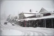  ?? ELIAS FUNEZ — THE UNION VIA AP ?? Vehicles make their way along Main Street in Grass Valley on Tuesday.