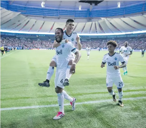  ?? THE CANADIAN PRESS/DARRYL DYCK ?? The Vancouver Whitecaps’ Kendall Waston, Fredy Montero — riding his teammate’s back — and Yordy Reyna, right, celebrate Waston’s goal against the San Jose Earthquake­s during the second half of their playoff game on Wednesday night at B.C. Place Stadium.