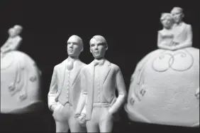  ?? TOM GRALISH/PHILADELPH­IA INQUIRER ?? Wedding cake toppers for same-sex couples by Kish & Company. A bakery owner will soon go before the Supreme Court over his refusal to make a cake for a same-sex wedding.