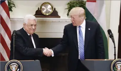  ?? POOL, GETTY IMAGES ?? U.S President Donald Trump shakes hands with President Mahmoud Abbas of the Palestinia­n Authority after a joint statement on Wednesday.