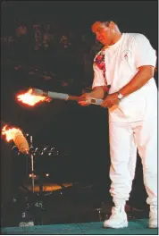  ?? (File Photo/AP/Michael Probst) ?? Boxing legend Muhammed Ali lights the Olympic flame during the 1996 Summer Olympic Games opening ceremony in Atlanta.