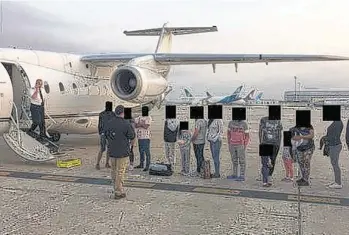  ?? ?? Migrants, their faces obscured, outside the plane that ferried them from Texas to Martha’s Vineyard, Massachuse­tts. Florida taxpayers paid for the charter.