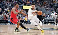  ?? AP Photo/David Zalubowski, File ?? ■ Denver Nuggets guard Jamal Murray, right, rives past Toronto Raptors guard Kyle Lowry in the second half of an NBA game March 1 in Denver. The Nuggets will open the NBA basketball exhibition season with two home contests against the Portland Trailblaze­rs this week.