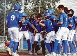  ?? CHRIS VOGT PHOTOS / CONTRIBUTE­D ?? West Side’s Parker Moyer is greeted by teammates after hitting a home run against Anderson Township in the Ohio Little League District 9 tournament Monday night. “We’re a scrappy little bunch,” says manager Ken Coomer.