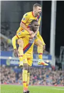  ??  ?? Palace’s Christian Benteke, bottom, celebrates his goal with James McArthur.