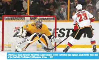  ?? — AFP ?? NASHVILLE: Sean Monahan #23 of the Calgary Flames scores a shootout goal against goalie Pekka Rinne #35 of the Nashville Predators at Bridgeston­e Arena.