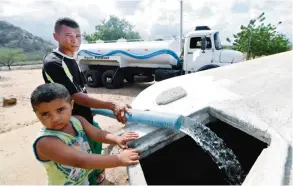  ??  ?? QUIXERAMOB­IM: A man fills a community cistern with water from a water truck in the rural area of Quixeramob­im, in Ceara State, on February 8, 2017, during the worst drought in 100 years in the Brazilian Northeast. —AFP photos