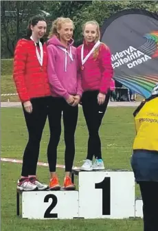  ??  ?? Jodie Robertson on the podium with her high jump medal.