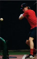  ?? HERALD PHOTO BY JUSTIN SEWARD ?? PBA’s Marc Brisson takes batting practice at Lloyd Nolan Yard’s indoor facility recently. The Dawgs have not seen outside practice time yet during this regular season due to the weather which is impacting player routine.