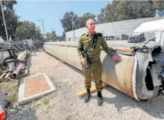  ?? // AFP ?? El portavoz militar israelí, Daniel Hagari, junto a un misil balístico iraní que cayó en Israel