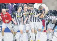  ??  ?? Happy days Saints celebrate Steven Thompson’s late winner while Kenny McLean is delighted to have hit the back of the net with his penalty which drew the sides level