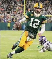  ?? Morry Gash/Associated Press ?? The Green Bay Packers’ Aaron Rodgers runs for a touchdown against the Minnesota Vikings on Jan. 1 in Green Bay, Wis.