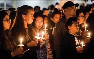  ?? LEO JARZOMB STAFF PHOTOGRAPH­ER ?? Arcadia High students and parents attend a vigil for slain students Anthony Lin, 15, and William Lin, 16, at the Arcadia, Calif. campus January 25, 2016. The brothers were allegedly beaten to death in their home by their uncle. Deyun Shi was convicted Wednesday.