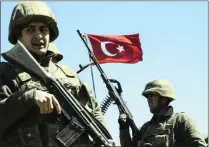  ?? PICTURE: AFP/AFRICAN NEWS AGENCY (ANA) ?? Turkish army soldiers stand guard as Kurdish people wait to enter the curfew town of Cizre.