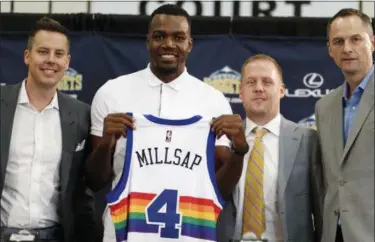  ?? DAVID ZALUBOWSKI — THE ASSOCIATED PRESS ?? New Nuggets forward Paul Millsap, second from left, holds up his jersey as Josh Kroenke, team president and governor, left, Tim Connelly, president of basketball operations and Arturas Karnisovas, general manager of the Nuggets, join in for a...