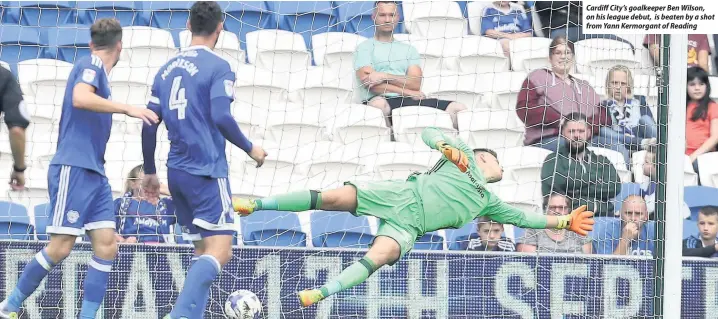  ??  ?? Cardiff City’s goalkeeper Ben Wilson, on his league debut, is beaten by a shot from Yann Kermorgant of Reading