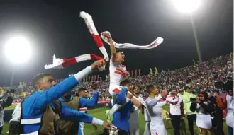  ??  ?? Zamalek’s Achraf Bencharki celebrates with teammates after winning the African Super Cup yesterday.