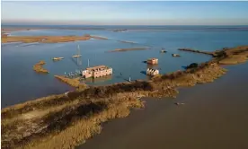  ?? Lops/The Guardian ?? Sunken buildings on Batteria, an island in the Po delta, affected over decades by flooding and subsidence aggravated by methane gas drilling. Photograph: Marta Clinco and Andrea