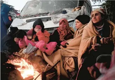  ?? OZAN KOSE/GETTY-AFP ?? Survivors displaced by a powerful earthquake sit near a bonfire Wednesday in Kahramanma­ras, Turkey.